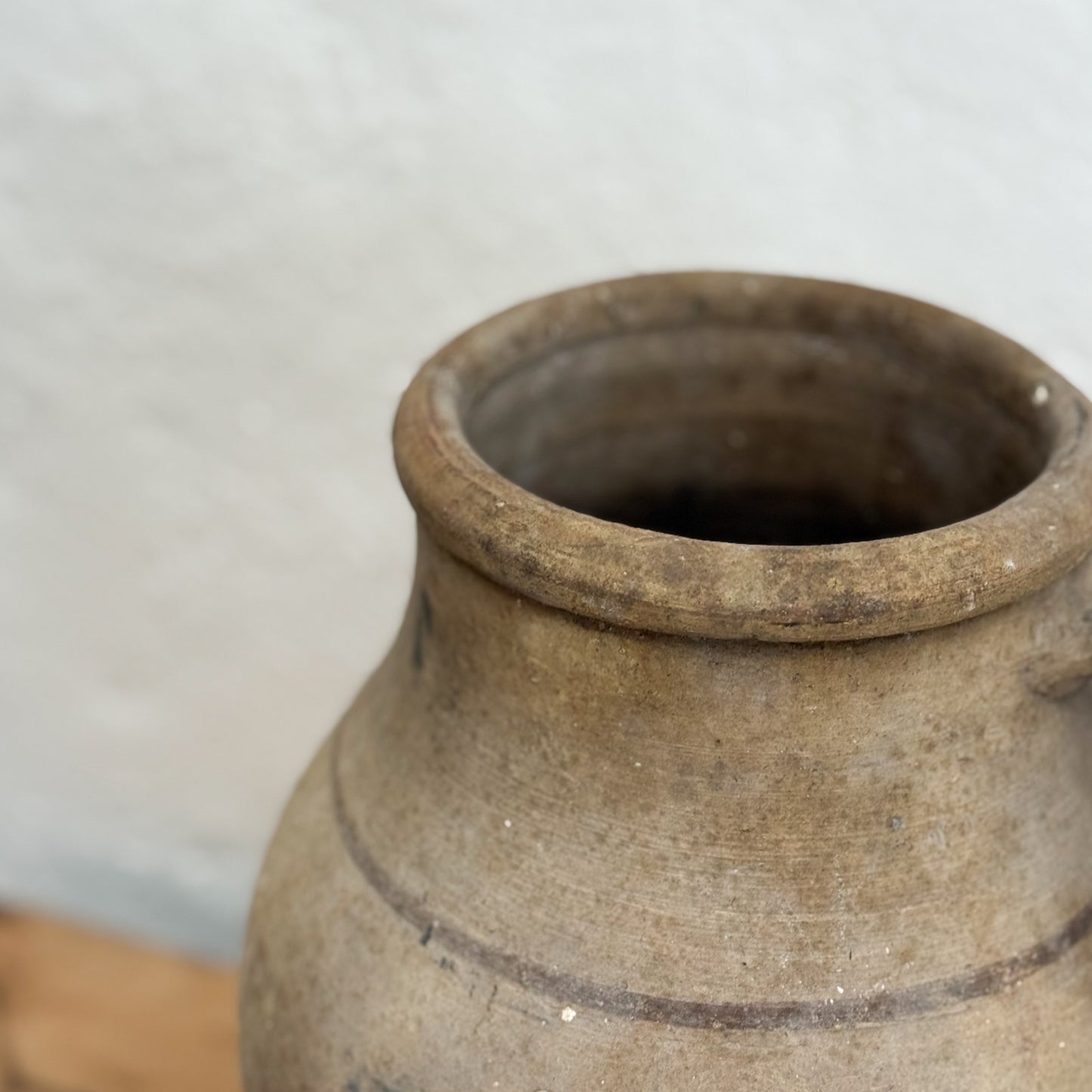 Close-up of a brown ceramic jar with a blurred background