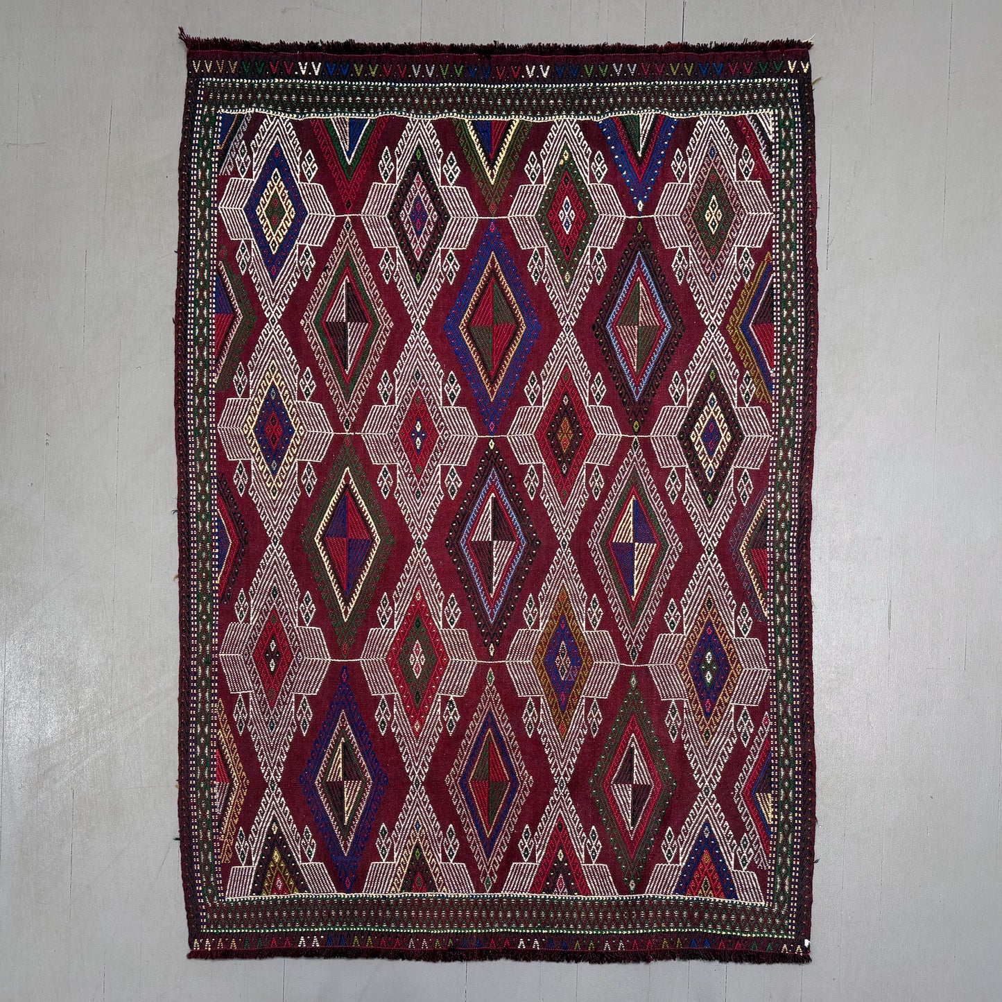 Decorative rug with geometric pattern on a plain background