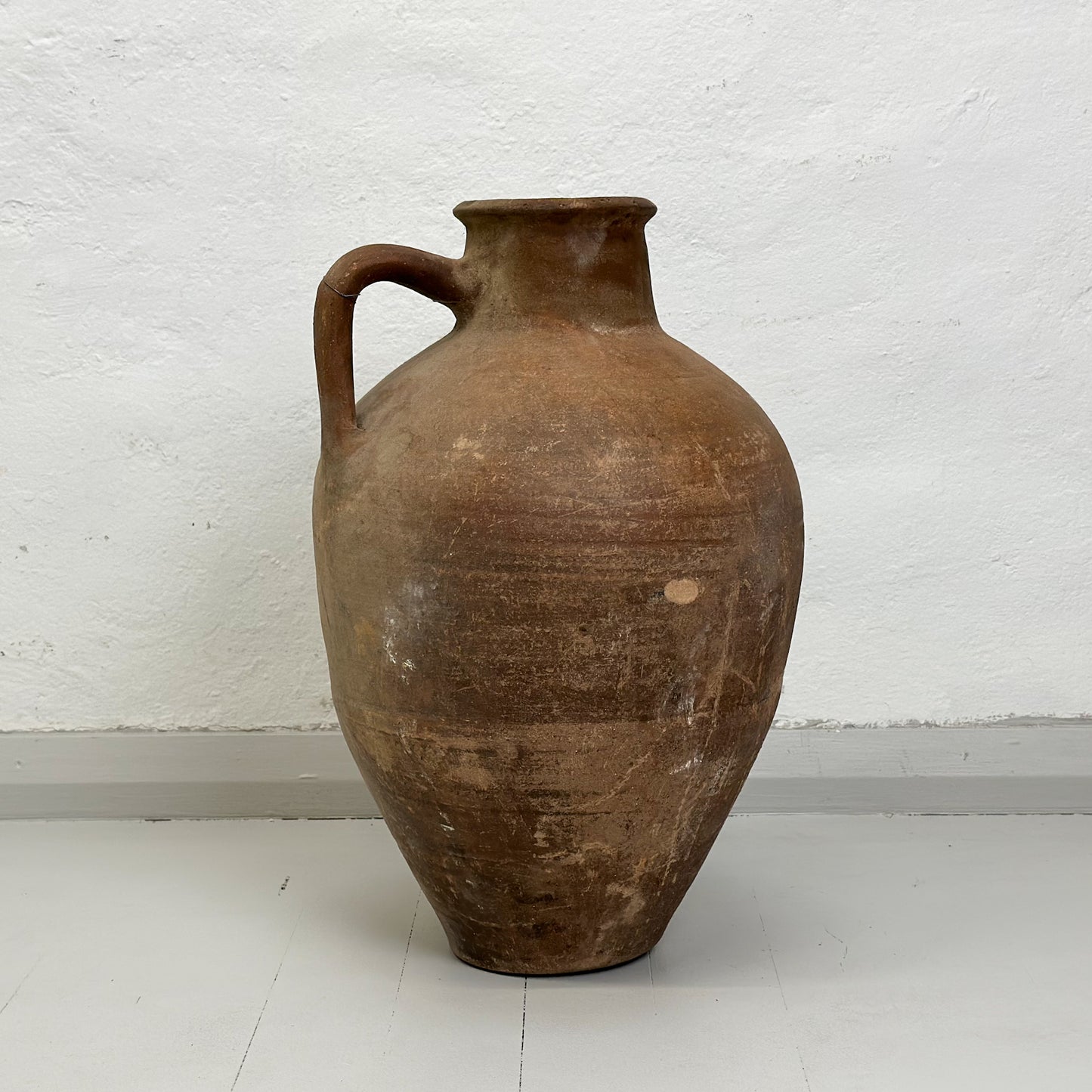 A brown ceramic Turkish milk churn pot with a handle, displayed against a white background.