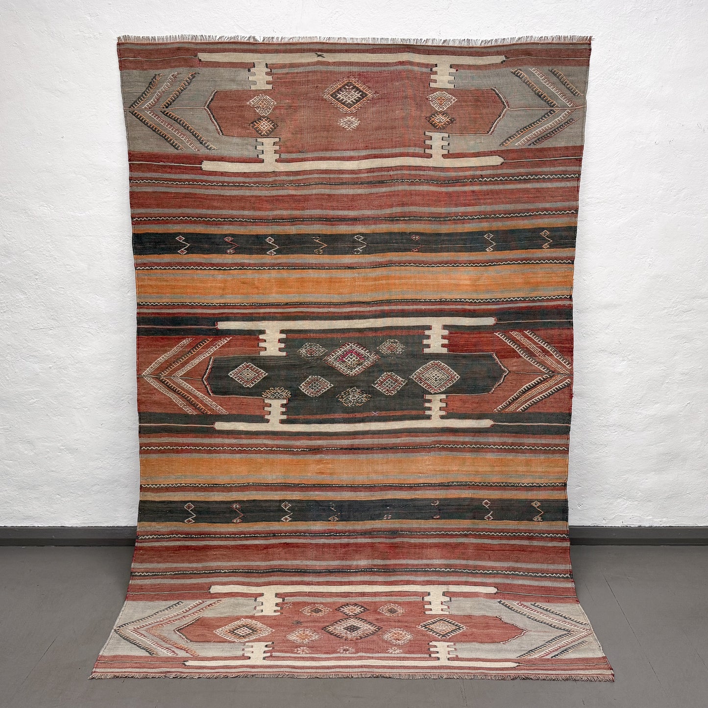 Multicolored patterned rug on a plain background