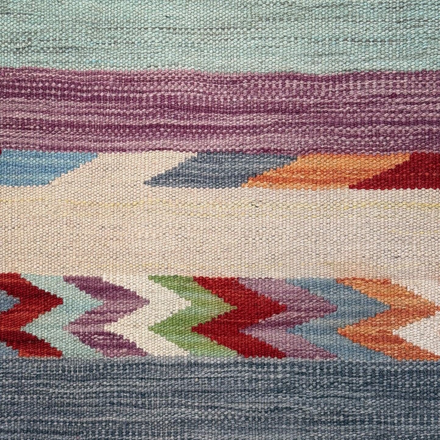 Close-up of a colorful woven textile with geometric pattern