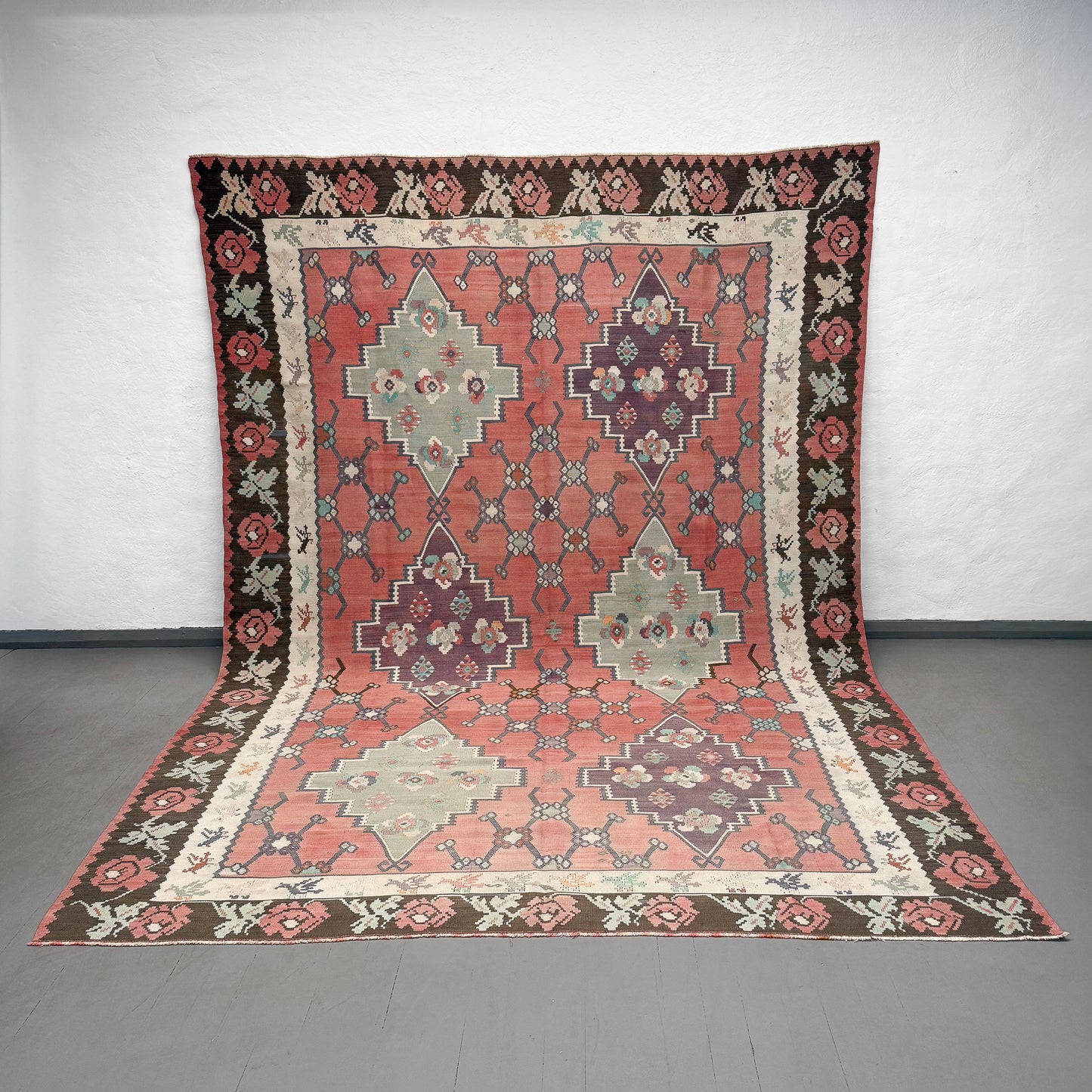 Decorative rug with geometric pattern on a plain floor