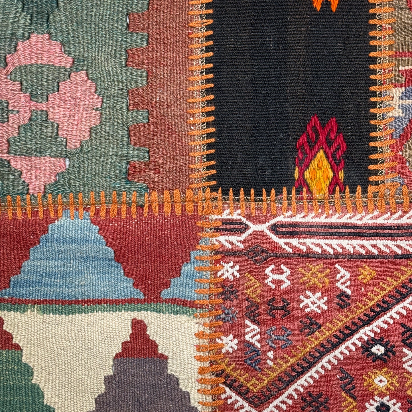 Close-up of a colorful woven textile with geometric patterns