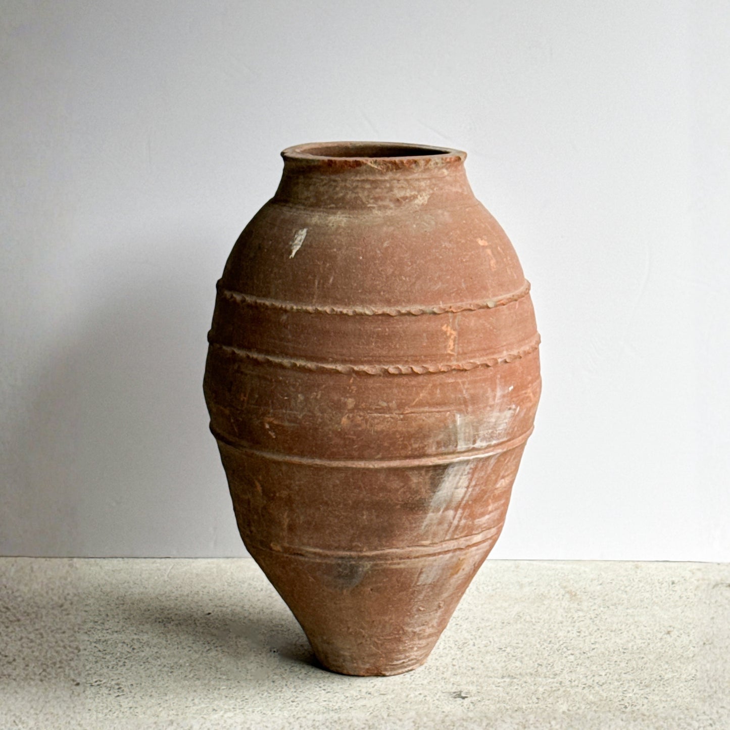 Terracotta vase on a neutral background
