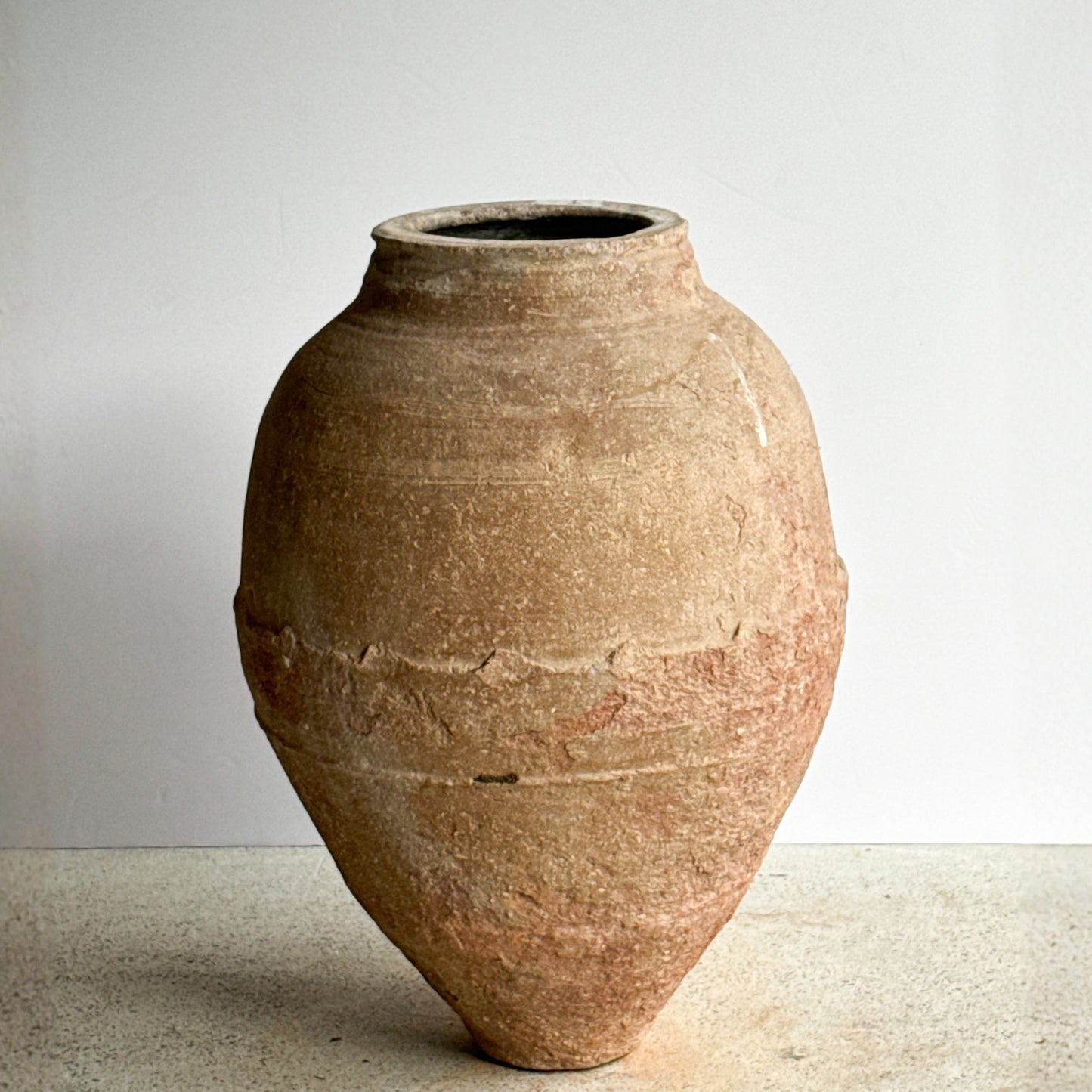 Brown ceramic vase on a light gray background