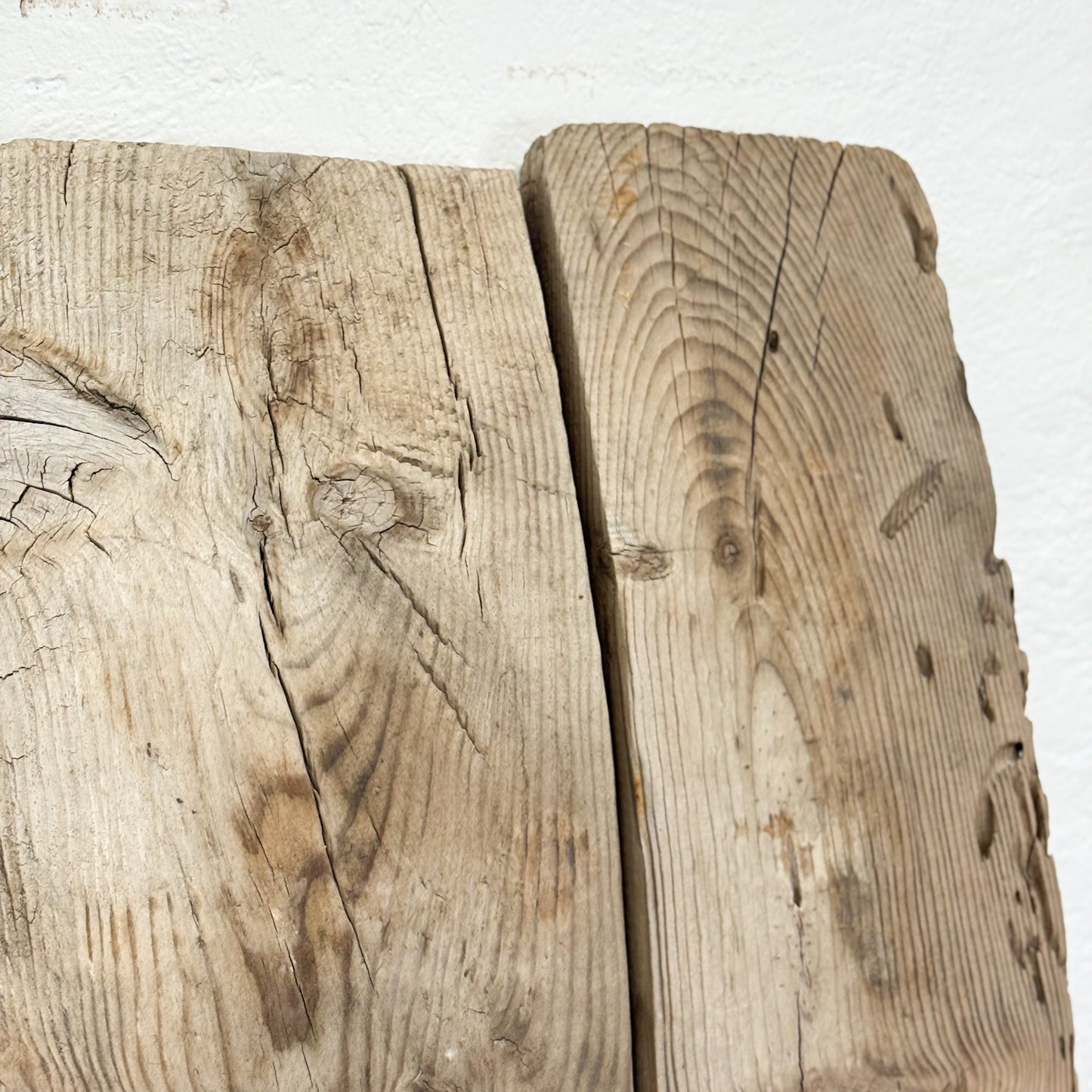 Close-up of two pieces of weathered wooden planks on a white background