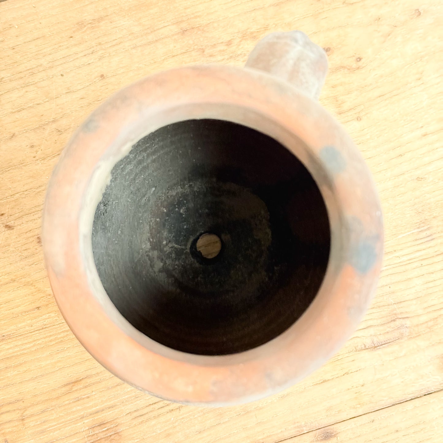Ceramic mug with a silicone lid on a wooden surface